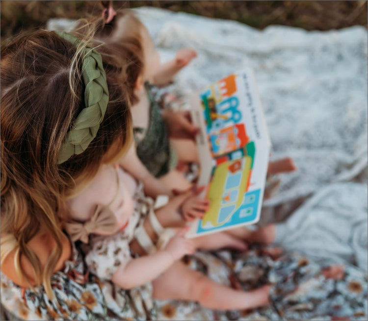 Graphic of Kendra James reading a book to her children